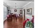 Elegant living room with a grand piano, hardwood floors and large windows at 310 Persimmon Dr, Sharpsburg, GA 30277
