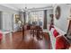 Elegant living room with a grand piano, hardwood floors, natural light and views to the front yard at 310 Persimmon Dr, Sharpsburg, GA 30277