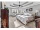 This bright main bedroom features a sitting area, ceiling fan and natural light at 310 Persimmon Dr, Sharpsburg, GA 30277