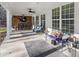 Expansive covered patio with outdoor bar area, ceiling fan, and comfortable lounge seating at 310 Persimmon Dr, Sharpsburg, GA 30277