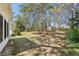 View of the backyard with mature trees providing lots of shade on a sunny day at 3100 Plantation Run Dr, Loganville, GA 30052