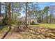 Backyard shot of home with mature trees providing lots of shade on a sunny day at 3100 Plantation Run Dr, Loganville, GA 30052