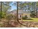 Backyard shot of home with mature trees providing lots of shade on a sunny day at 3100 Plantation Run Dr, Loganville, GA 30052