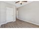 Bright bedroom with hardwood floors, neutral paint, two doors, and a ceiling fan creating a serene retreat at 3100 Plantation Run Dr, Loganville, GA 30052