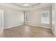 Neutral bedroom featuring light wood flooring, two windows, and recessed lighting at 3100 Plantation Run Dr, Loganville, GA 30052