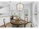 Inviting dining area with a round table, decorative chandelier, and natural light from the window at 3100 Plantation Run Dr, Loganville, GA 30052