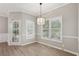 Bright dining area featuring modern lighting, neutral walls, and access to the outdoors, great for relaxation at 3100 Plantation Run Dr, Loganville, GA 30052