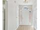Bright entryway featuring a white front door with sidelights and an arched transom window and neutral walls at 3100 Plantation Run Dr, Loganville, GA 30052