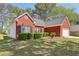 Exterior view of the house showcasing the brick facade, shutters and a well-maintained lawn at 3100 Plantation Run Dr, Loganville, GA 30052