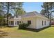 Back view of home with lush green lawn and swing and lots of mature trees at 3100 Plantation Run Dr, Loganville, GA 30052