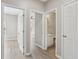 Hallway showcases natural light, hardwood floors, and access to the bathroom and bedroom at 3100 Plantation Run Dr, Loganville, GA 30052
