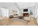 Light and bright living room with fireplace, wood flooring, and neutral color palette at 3100 Plantation Run Dr, Loganville, GA 30052