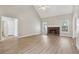 Spacious living room featuring a fireplace, high ceiling, neutral walls and light wood-look floors at 3100 Plantation Run Dr, Loganville, GA 30052