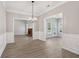 Open concept living space featuring hardwood flooring, neutral walls, and a cozy fireplace at 3100 Plantation Run Dr, Loganville, GA 30052