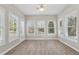 Sunroom features ample natural light with numerous windows and a ceiling fan for comfort at 3100 Plantation Run Dr, Loganville, GA 30052
