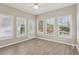 Bright sunroom with many windows, a ceiling fan, and easy access to the outdoors, great for relaxing at 3100 Plantation Run Dr, Loganville, GA 30052