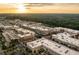 Expansive view of community with multiple buildings, parking lots, and green spaces at sunset at 7220 Summit Pl, Alpharetta, GA 30009