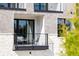 Cozy balcony with seating, enhancing the modern townhome's outdoor living space at 7220 Summit Pl, Alpharetta, GA 30009