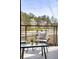 Relaxing balcony with outdoor chairs and a scenic view of the surrounding landscape at 7220 Summit Pl, Alpharetta, GA 30009
