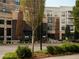 Modern building with brick and light-colored facades, balconies, and manicured landscaping at 7220 Summit Pl, Alpharetta, GA 30009
