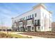 Townhome exterior with brick and white accents, highlighting modern design elements at 7220 Summit Pl, Alpharetta, GA 30009