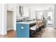 Bright kitchen with island, counter seating, white cabinets, and stainless steel appliances at 7220 Summit Pl, Alpharetta, GA 30009
