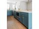 Modern kitchen with blue cabinets, stainless steel appliances, and hardwood floors at 7220 Summit Pl, Alpharetta, GA 30009