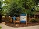 Wills Park community playground with unique, custom structures set in a shaded, natural setting at 7220 Summit Pl, Alpharetta, GA 30009