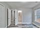 Spacious bedroom featuring grey-toned wood-look flooring, neutral walls, and an ensuite bathroom at 10540 Willow View Cir, Alpharetta, GA 30022
