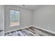 Neutral bedroom features gray-toned wood floors and plenty of natural light at 10540 Willow View Cir, Alpharetta, GA 30022