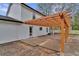 View of the rear of the home featuring a pergola covered patio and backyard at 10540 Willow View Cir, Alpharetta, GA 30022