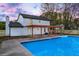 Charming home exterior with refreshing in-ground swimming pool and covered outdoor patio at 10540 Willow View Cir, Alpharetta, GA 30022