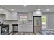 Open-concept kitchen with modern appliances and backyard access at 10540 Willow View Cir, Alpharetta, GA 30022