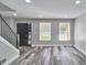 Bright living room with modern gray wood floors and crisp white trim, flooded with natural light at 10540 Willow View Cir, Alpharetta, GA 30022