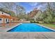 Backyard view of the home showcasing a refreshing in-ground pool, and landscaping at 10540 Willow View Cir, Alpharetta, GA 30022