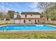 Backyard view of the home showcasing a pergola, patio, and inviting pool at 10540 Willow View Cir, Alpharetta, GA 30022