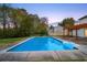Beautiful pool area with lush landscaping and a pergola for outdoor relaxation at 10540 Willow View Cir, Alpharetta, GA 30022