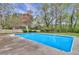 Backyard view of the home showcasing a refreshing in-ground pool, and landscaping at 10540 Willow View Cir, Alpharetta, GA 30022