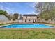Backyard pool surrounded by a well-maintained lawn and wooden pergola at 10540 Willow View Cir, Alpharetta, GA 30022