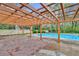 View of the pergola covered patio and a refreshing in-ground pool at 10540 Willow View Cir, Alpharetta, GA 30022