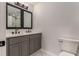 Bathroom vanity with double sinks, sleek mirrors, black hardware, and a peek at a walk-in shower at 2562 Tritt Springs Ne Trce, Marietta, GA 30062