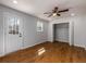 Bedroom with hardwood floors, a ceiling fan, closet with bi-fold doors, and a door to the backyard at 2562 Tritt Springs Ne Trce, Marietta, GA 30062