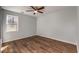 Bedroom with wood floors, neutral walls, and window letting in natural light at 2562 Tritt Springs Ne Trce, Marietta, GA 30062