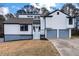 Charming two-story home boasts a clean white exterior, gray trim, and a two-car garage at 2562 Tritt Springs Ne Trce, Marietta, GA 30062