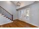 Bright foyer featuring hardwood floors, staircase with wooden railing, and natural light from the front door at 2562 Tritt Springs Ne Trce, Marietta, GA 30062