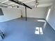 Spacious two-car garage with gray epoxy flooring and updated lighting, offering ample storage and functionality at 2562 Tritt Springs Ne Trce, Marietta, GA 30062