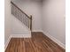 Hallway featuring wood-look floors and a staircase with dark wood handrail and wrought iron spindles at 2562 Tritt Springs Ne Trce, Marietta, GA 30062