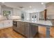 Kitchen featuring a large gray island, stainless appliances, granite countertops and a window above the sink at 2562 Tritt Springs Ne Trce, Marietta, GA 30062