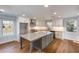 Bright kitchen features a center island, granite counters, white cabinets, and stainless steel appliances at 2562 Tritt Springs Ne Trce, Marietta, GA 30062