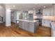Spacious kitchen features a large island with gray cabinets, stainless appliances, and granite countertops at 2562 Tritt Springs Ne Trce, Marietta, GA 30062